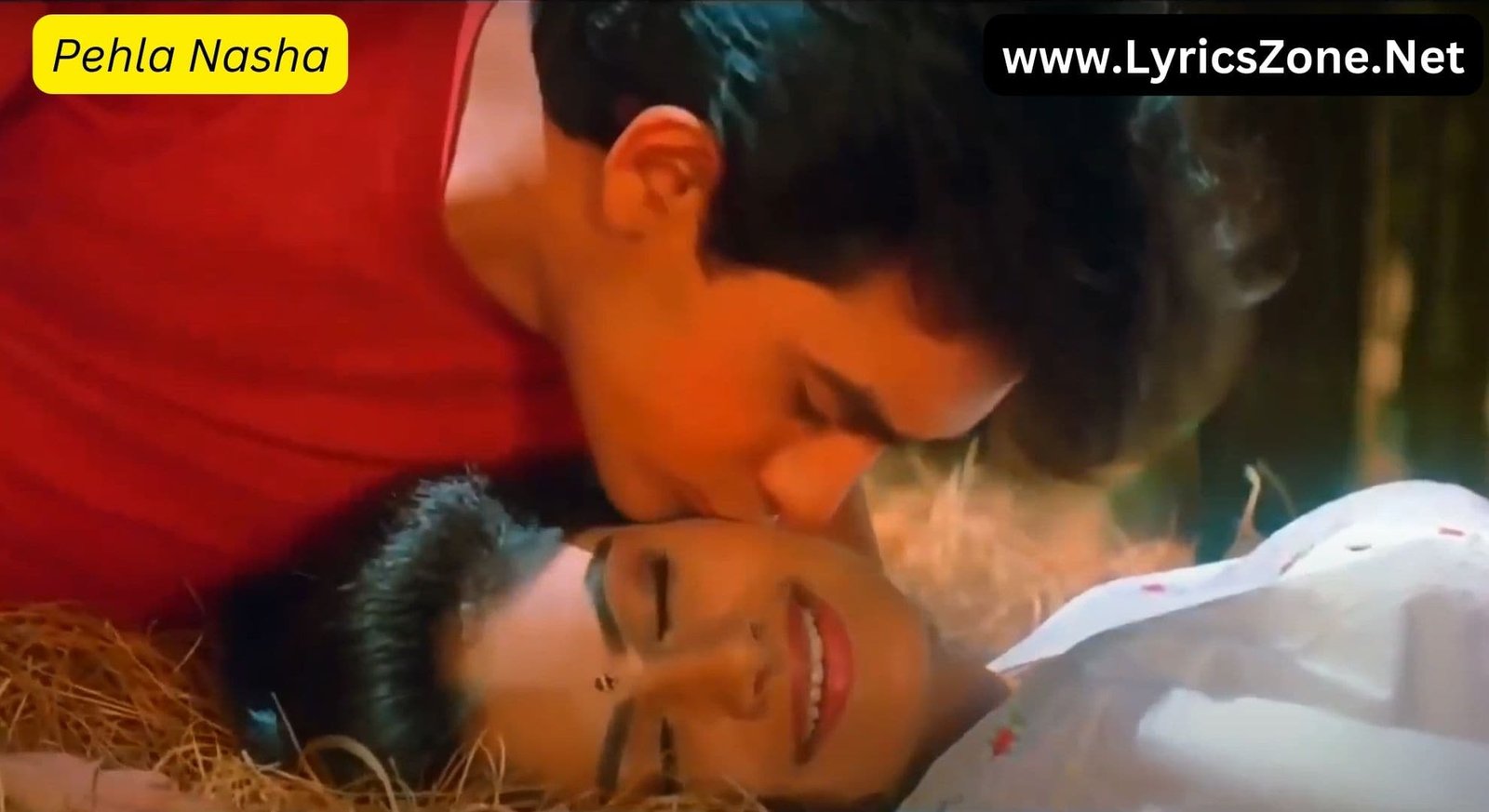 Aamir Khan kisses Ayesha Jhulka on the cheek in a romantic scene from the song "Pehla Nasha." The image is from the popular Bollywood song, and you can find the Pehla Nasha lyrics to enjoy the full experience.